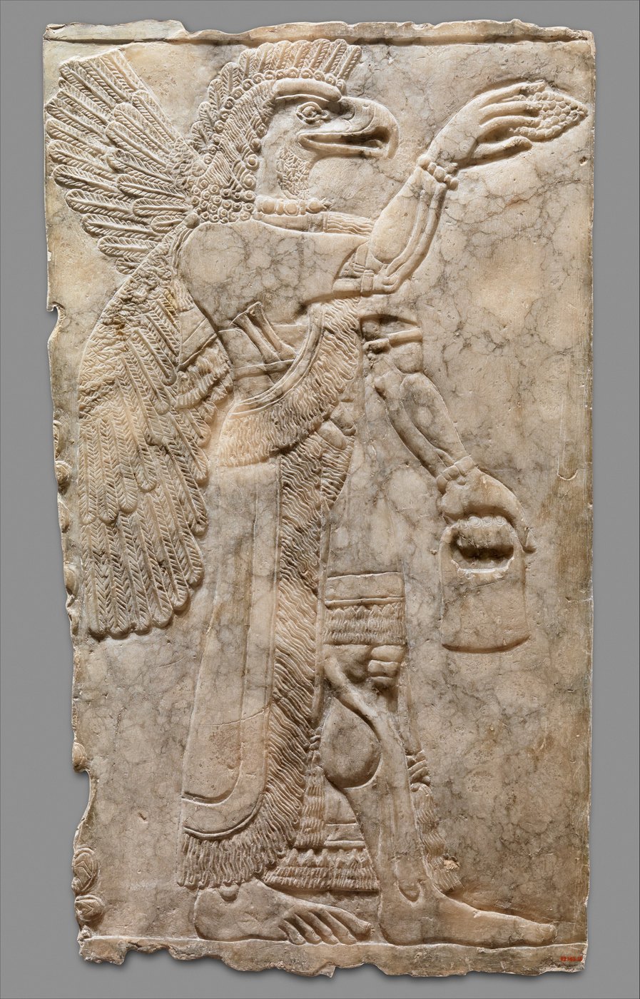 Eagle-headed figure with the bucket and the cone